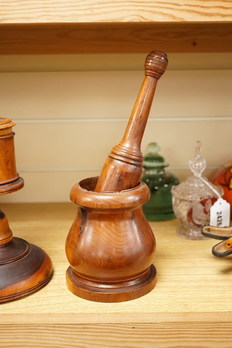 A 19th century treen lignum vitae pestle and mortar and turned cup and cover on stand- 25cm high